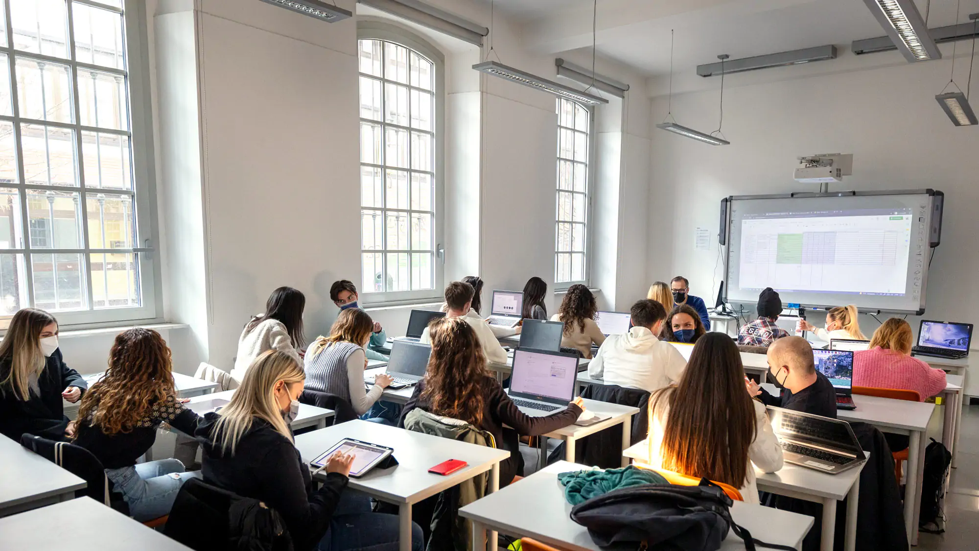 A classroom full of students with laptops at IAAD University during an Interior design lesson