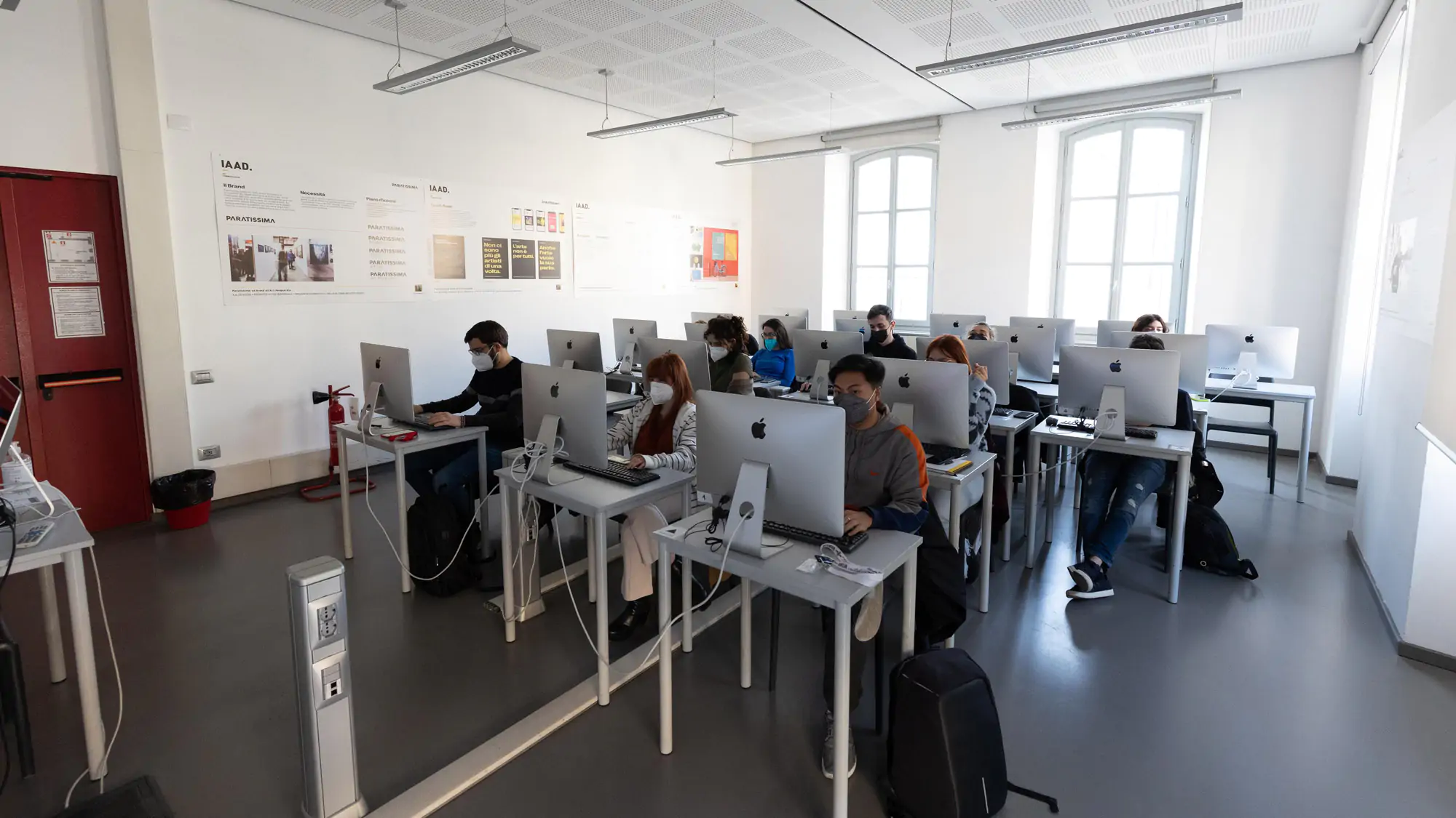 Classroom scene at IAAD university, Master in Digital Marketing lesson, students working on computers