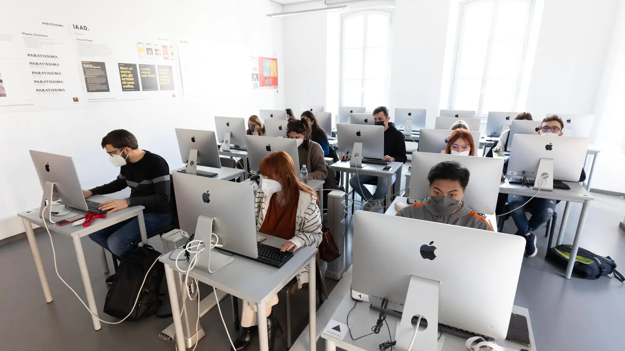 Students at IAAD university attending a Master in Digital Marketing class, seated at desks with computers