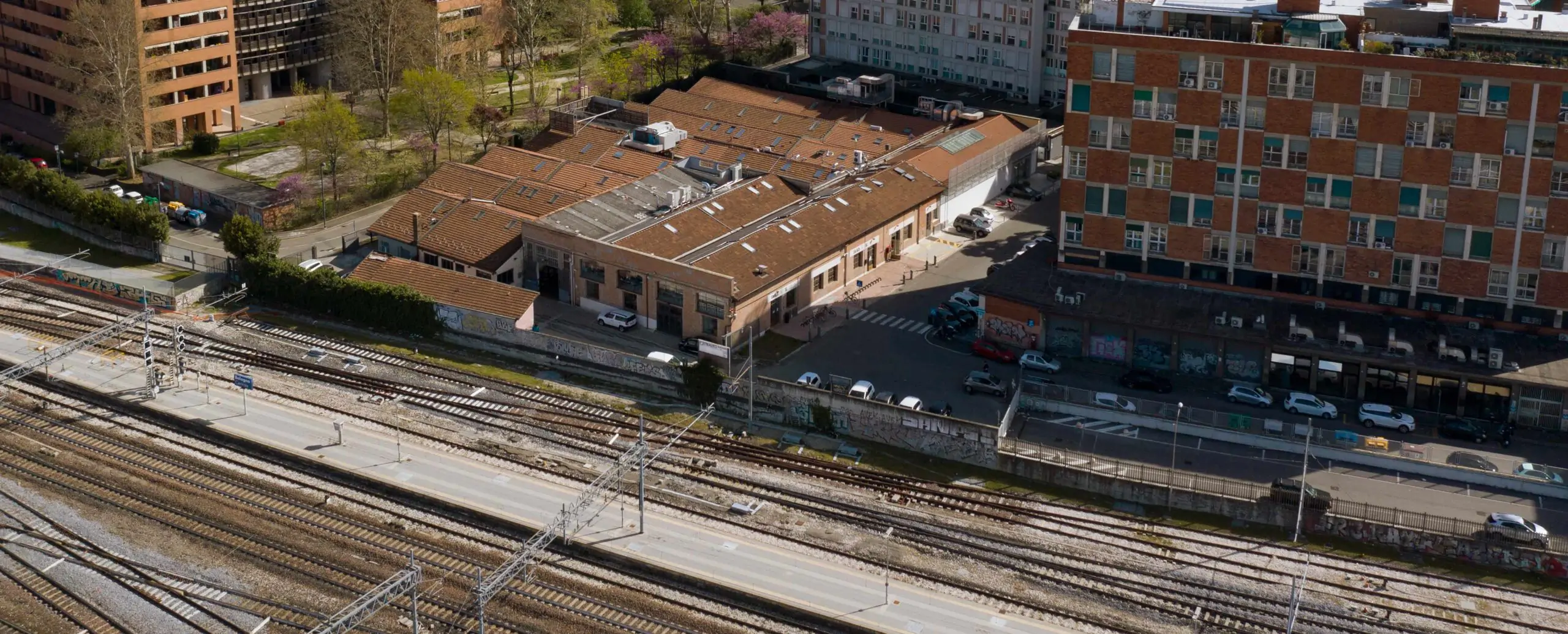 A photo in perspective with the IAAD Bologna campus and the nearby central station of Bologna